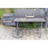 A freestanding painted steel pizza oven, with twin lidded hinged compartmentsQuite wobbly.The