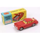 Corgi Toys No. 218 Aston Martin DB4, red body, with a yellow interior, and criss cross wheels,