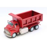 Yonezawa (Japan) battery-operated lift dump truck, comprising red cab, chassis and back, with