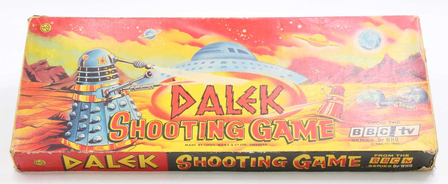 A Louis and Marx Toys Doctor Who Dalek shooting game copyright 1965. Set includes a cork gun, four