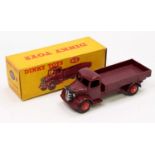 A Dinky Toys No. 412 Austin wagon comprising of dark maroon body with red Supertoys hubs housed in