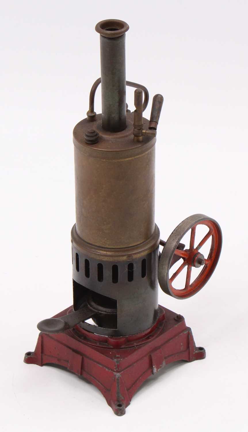 A Bing style or similar vertical spirit fired steam engine comprising of red painted cast metal base