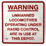 An original aluminium 1980s railway warning sign to read "Unmanned locomotives, operating under