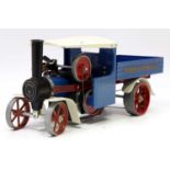 A Mamod SW1 steam wagon comprising of blue and white body with red spoked wheels, complete with