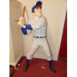 A painted composite life-size standing figure of a baseball player holding a bat, h.177cm