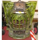An early 20th century French green enamelled iron stove, the hinged upper compartment initialled ACC