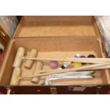 A metal bound trunk containing croquet set including four mallets