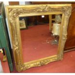 A late 19th century floral giltwood and gesso decorated rectangular wall mirror (mirrorplate is