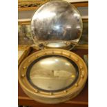A convex wall mirror in a slim gilt mount, dia. 62cm, together with one other in ball applied frame,