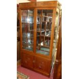 A Chinese contemporary hardwood double door glazed display cabinet, having interior sectional