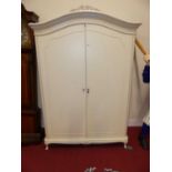 A contemporary white wood French style double door wardrobe by Laura Ashley, raised on squat