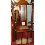 A late Victorian walnut mirror back hall stand