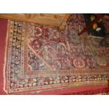 A Persian woollen red ground Tabriz rug (faded and worn to surface), 325 x 225cm