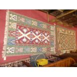 A collection of three various similar Turkish woollen bright coloured Kelim rugs, the largest 205