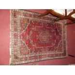 A Persian woollen red ground Shiraz rug, 160 x 123cm