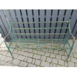 A probably Regency period green painted iron strapwork four-seater garden bench, with reeded detail,