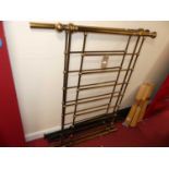 A contemporary polished tubular brass double bedstead, with side rails, central supporting bar,