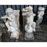 A pair of white painted reconstituted stone garden statues, one modelled as Pan seated on a finial
