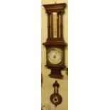 An early 20th century relief carved oak two-dial aneroid barometer; together with a small carved