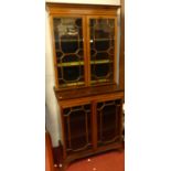An Edwardian mahogany and satinwood crossbanded bookcase cabinet, the twin astragal glazed upper