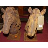 A pair of contemporary cast iron horse-head garden ornaments, h.45cm These are new, and artificially