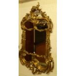 A contemporary Rococo Revival floral gilt decorated large wall mirror, having all-over scroll,