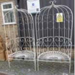 A pair of contemporary white painted scroll and strap work metal demi-lune twin arbour seats, each