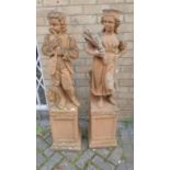 A pair of terracotta effect reconstituted stone garden statues, modelled as a male and female figure