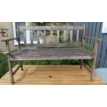 A stained and slatted teak two-seater garden bench, width 119cm