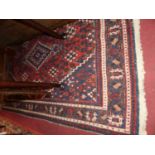 A Persian woollen red and blue ground Shiraz rug, 195 x 132cm