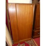 A 1960s teak tambour single door wardrobe, w.90cm