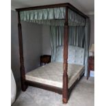 A mahogany double full tester bed, having reeded and spiral turned columns, buttoned silk fabric,