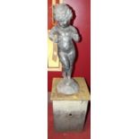 An early 20th century lead figure of a standing nude boy, on naturalistic base, raised on further
