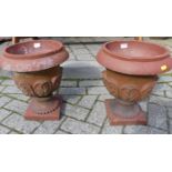 A pair of small terracotta footed circular planters, with raised outer leaf decoration, dia. 31.5cm,