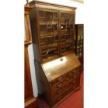 A George III mahogany bureau bookcase, having twin astragal glazed upper doors (some glass panels
