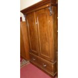 A mid-Victorian mahogany double door wardrobe, the twin arched panelled doors enclosing five linen