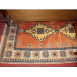 A Turkish woollen cream and rust ground rug, having all-over geometric floral motifs, 215 x 128cm
