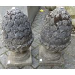 A pair of reconstituted stone garden ornamental pineapple finials, h.50cm