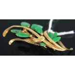 A contemporary yellow metal and green hardstone set leaf brooch, stamped 14k and tested as 14ct