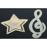 A Tiffany & Co sterling silver star shaped paperclip and another as a treble clef; together with a