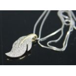 A contemporary 9ct gold diamond point set leaf pendant, 25mm, on a silver finelink neck chain, gross