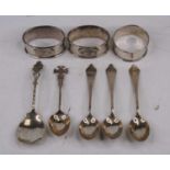 A set of three George VI silver tea spoons, Sheffield 1943, together with three silver napkin rings,