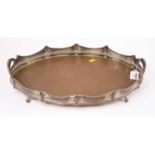 An Edwardian silver plated tray, of twin handled oval shape, having a raised pierced gallery,