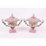 A pair of Sevres style lidded urns, each decorated with flowers, h.20cm