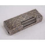 A Dunhill textured white metal pocket cigarette lighter, stamped 'US RE 24163 patented, Made in