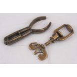 A 19th century brass thumbscrew/nut cracker, having a batwing shaped handle, max length 8cm;
