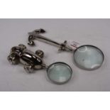 Two plated metal novelty magnifying glasses, largest 30cm