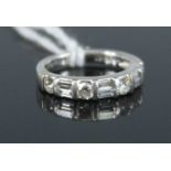 A contemporary platinum and diamond half hoop ring, arranged as four round brilliant cut diamonds,