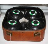 A set of four boules, in travel case