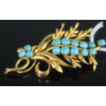 A contemporary yellow metal turquoise set leaf and flower brooch, stamped 14k and tests as approx